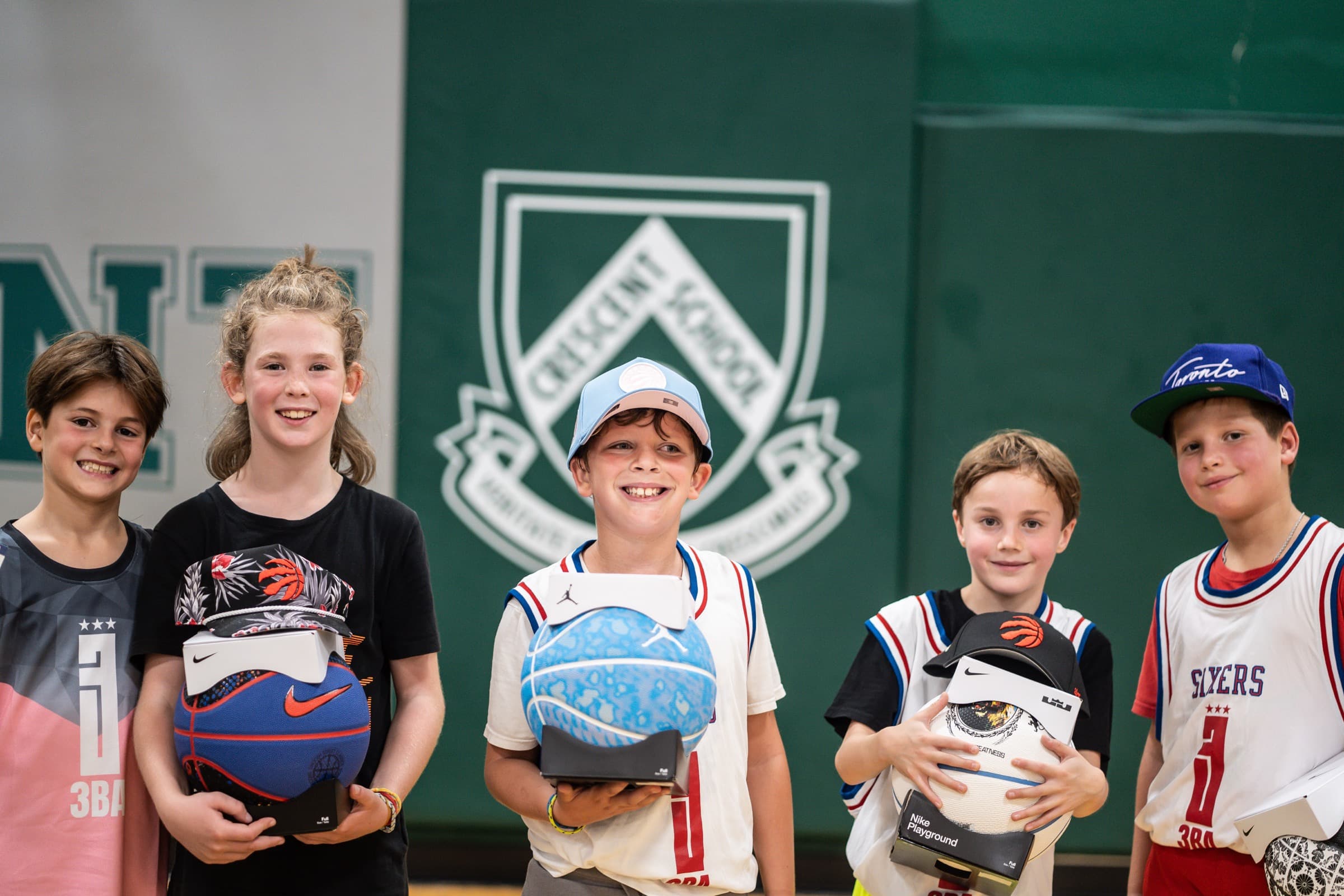 League award winners smiling with their prize sneakers