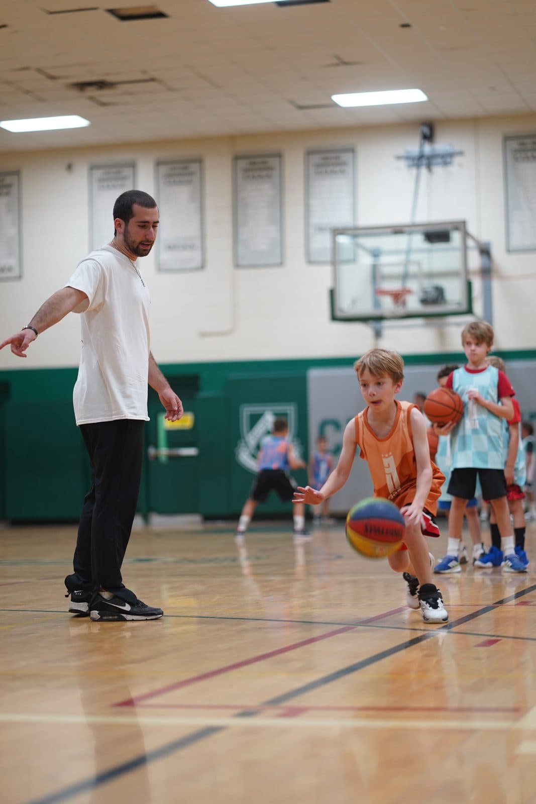 A coach cheering on a young player attacking off the dribble