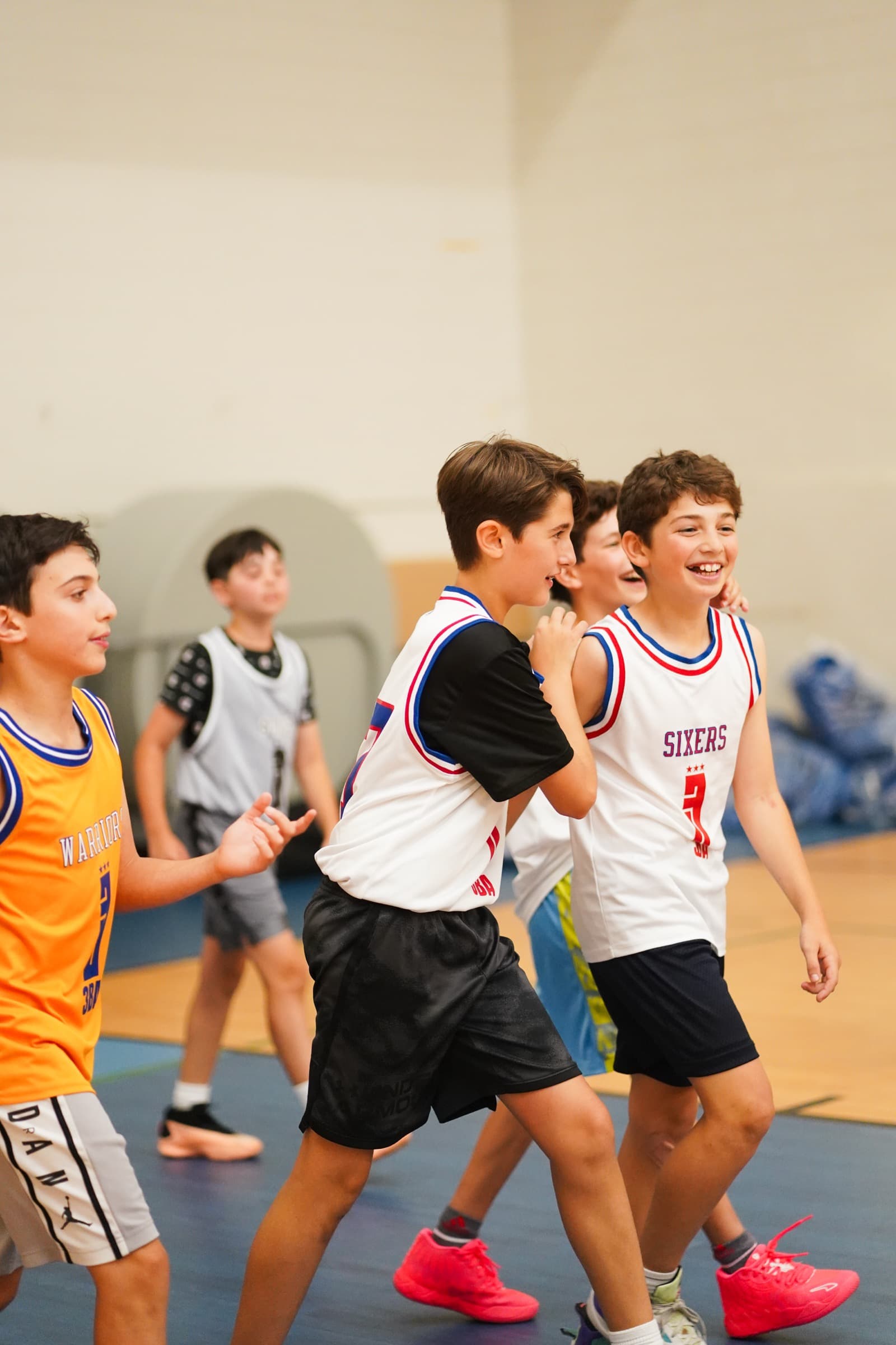 Teammates in 3BA jerseys jogging back up the floor, laughing after a made basket