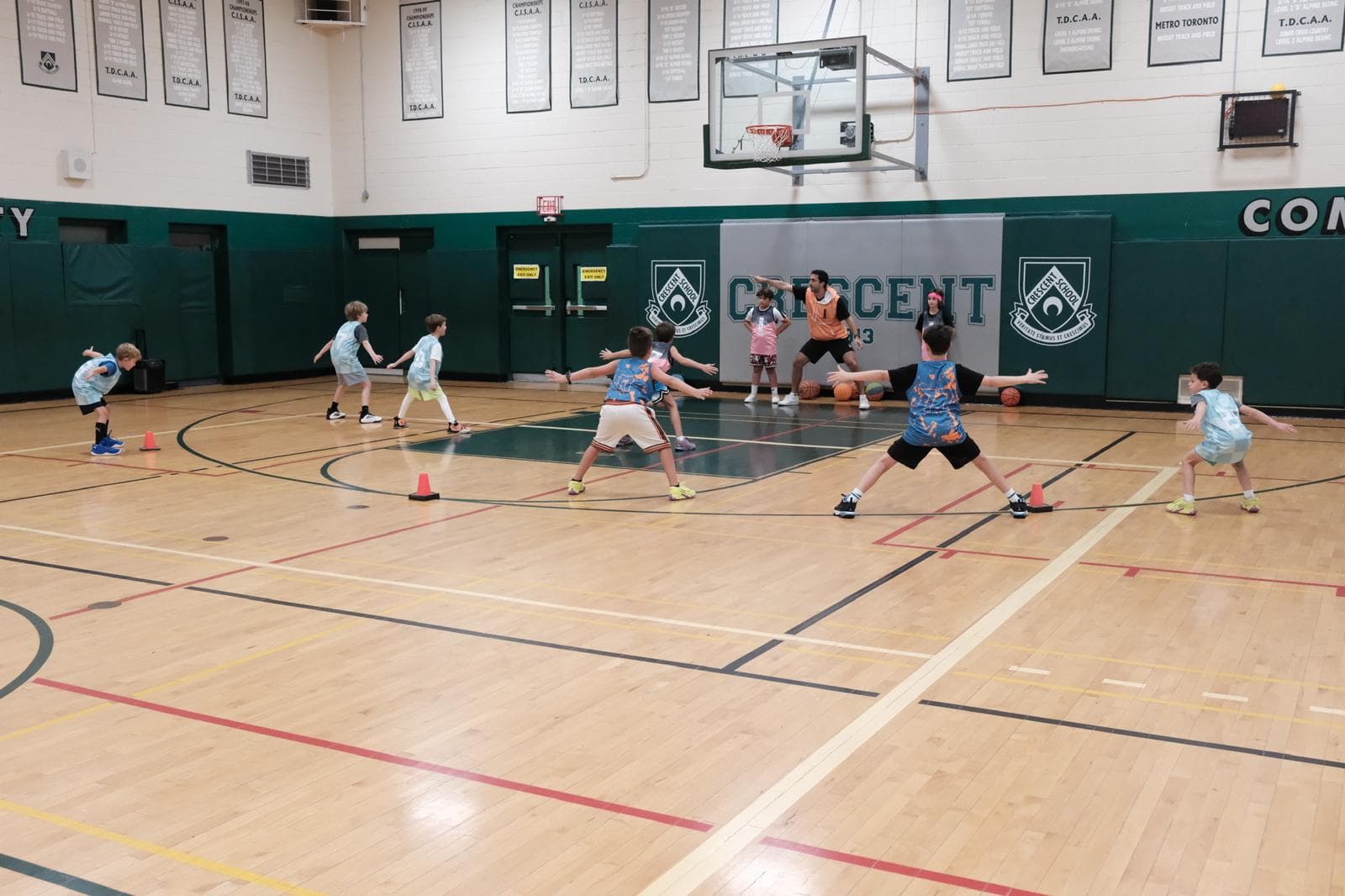 Young Next Gen athletes in defensive stance during a coached drill