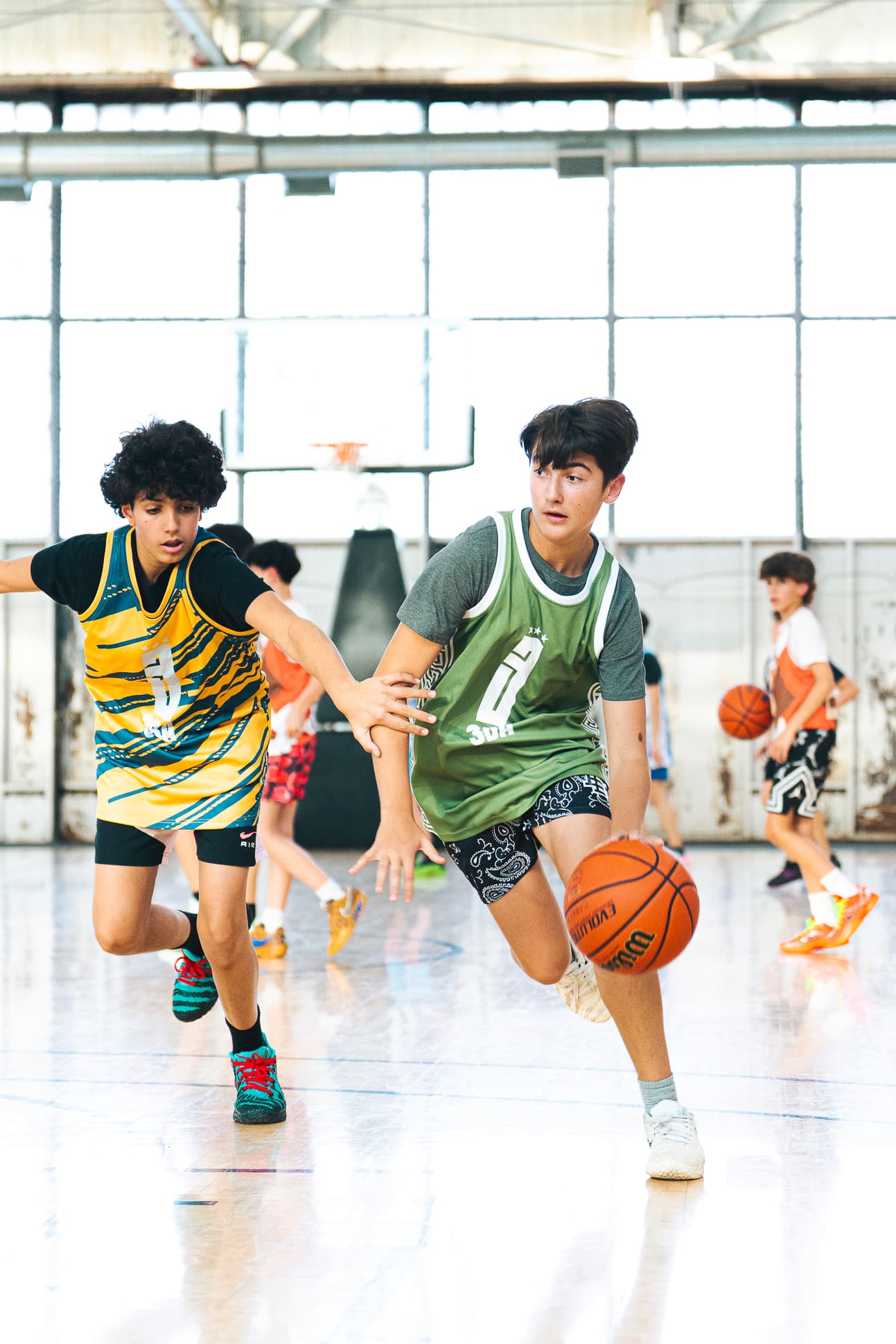 A Youth division player driving past a defender in a 3x3 game